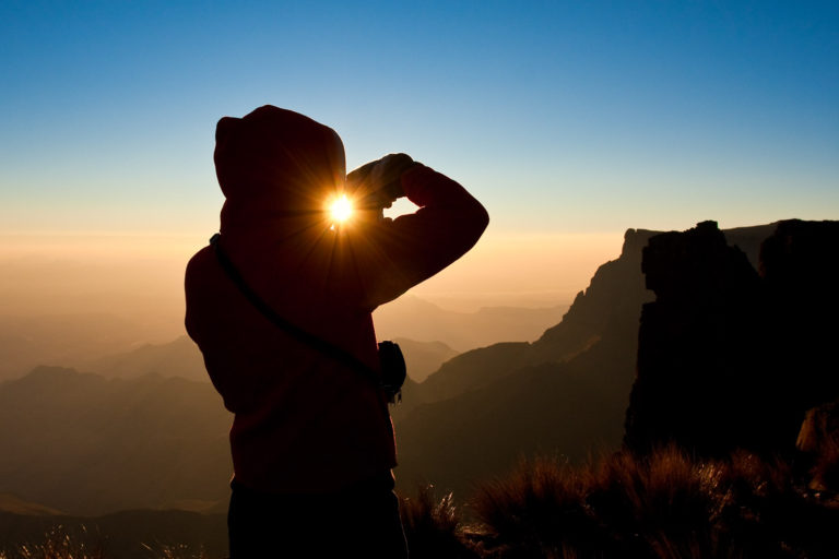 hiker sunrise mountains