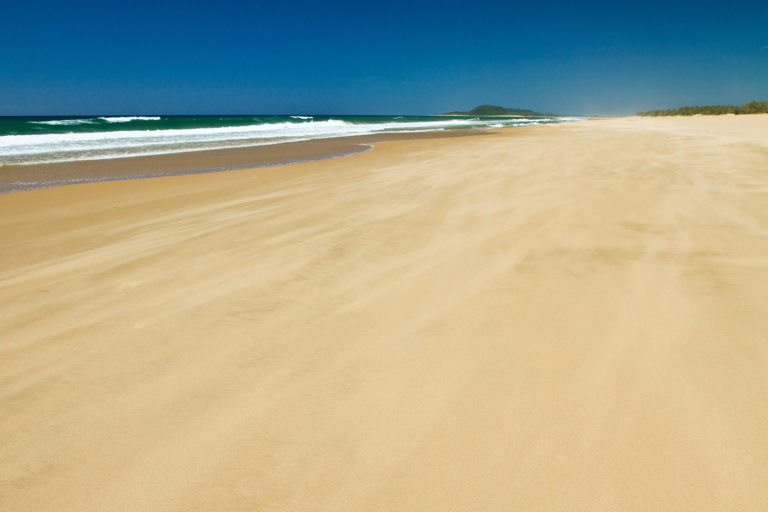 Beach sand ocean blue sky