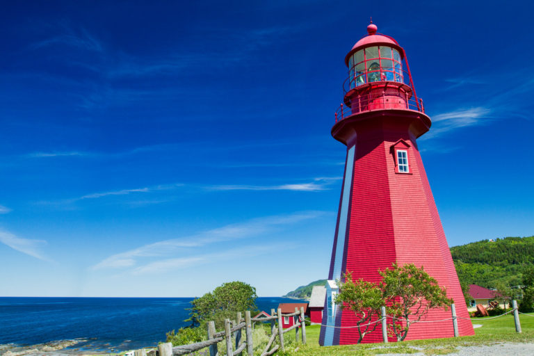 red lighthouse ocean blue sky