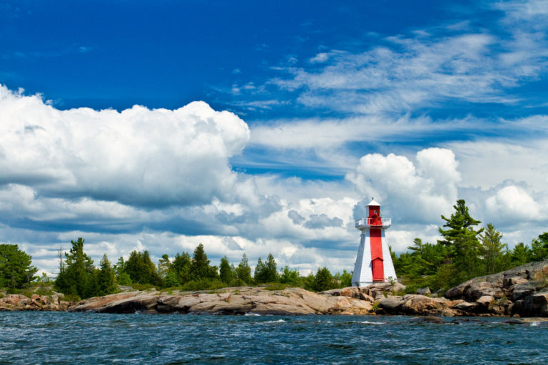 lighthouse clouds blue sky